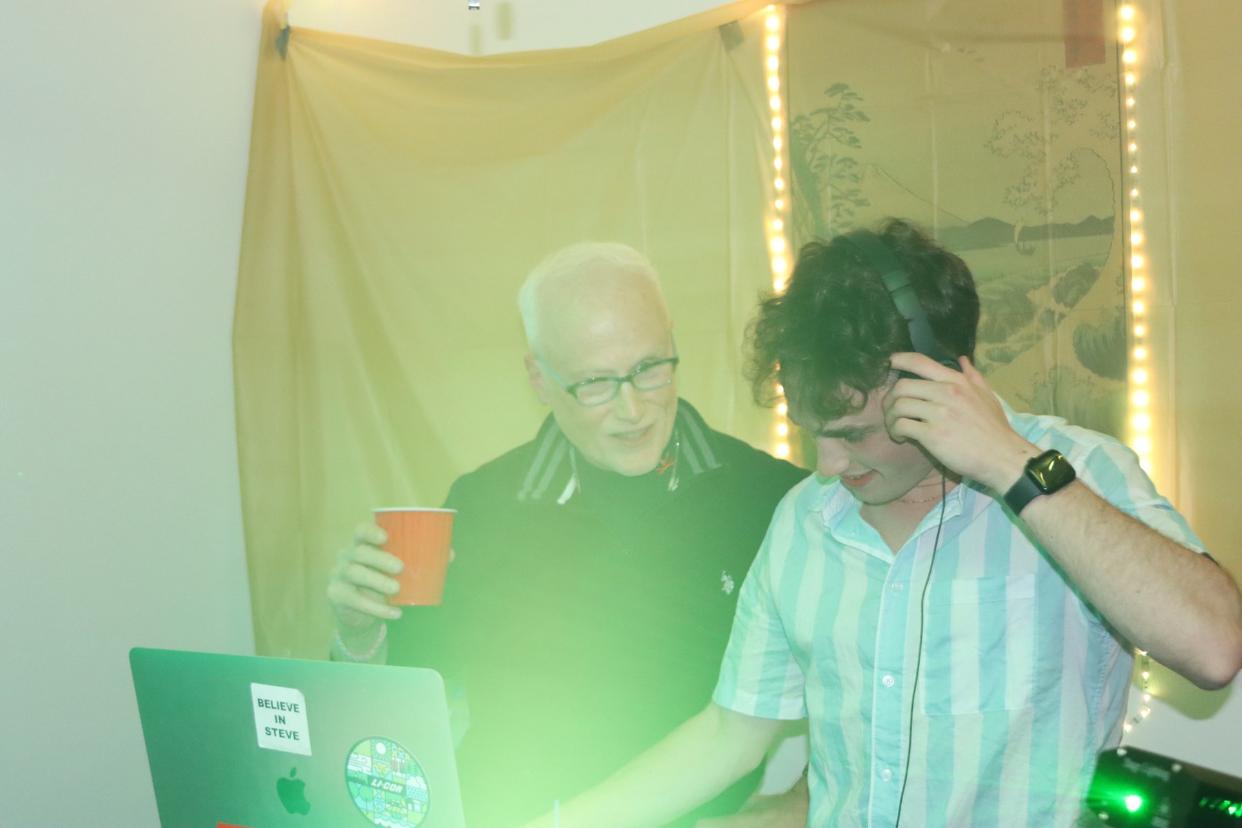 DJ sharing a moment with a guest behind the booth